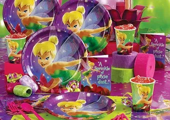 Themed party tableware set with plates, cups, napkins and table cover laid out