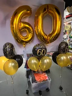Gold number 60 foil balloons with black and gold balloon bunch for a milestone birthday