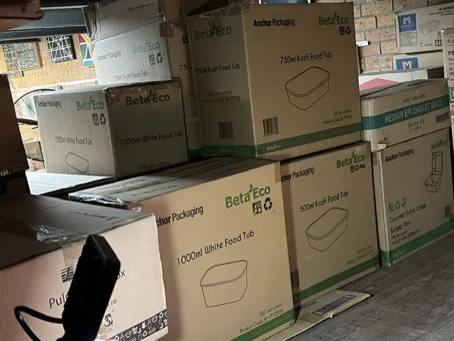 Cartons of food tubs and takeaway containers in the Tuncurry storeroom