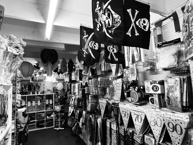 Party shop aisle with costumes, wigs and party hats in Tuncurry